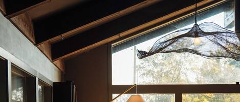 A cozy seating area with a table, chairs, and a hanging light fixture.