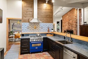 Enjoy cooking in this well-equipped kitchen with a central island, gas stove, and oven.