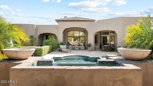A modern house with a swimming pool, outdoor seating, and a patio area. - Scottsdale Paradise- POOL, Spa, Pickleball/Basketball, Fire Pit & Great HIKING! (Scottsdale)