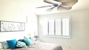 A bedroom with a bed, a ceiling fan, a window with blinds, and a wall-mounted picture. - Bright, Safe, Comfortable 3Bdrm in Bradenton, FL.  Pool, Tennis, Golf,  Beaches. (Bradenton)