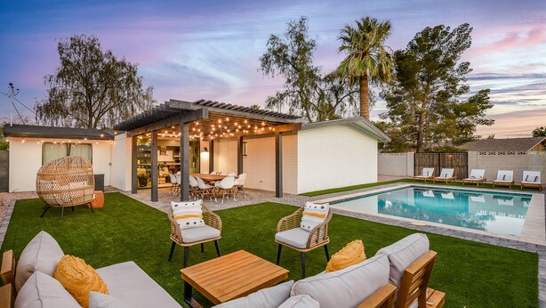 A backyard with a pool, outdoor seating, and a covered patio area. - Closest Walk to Old Town, Entertainment District (Scottsdale)