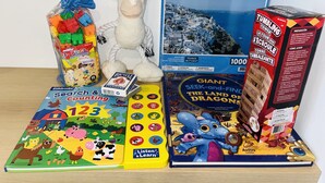 A variety of children's toys and books, including a puzzle, a stuffed animal, and a book titled 'Giant Seek-and-Find the Land of Dragons'. - Brand New Modern Luxury Villa (London)