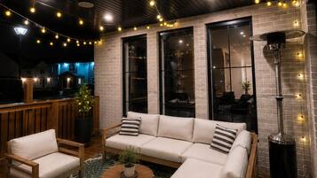 An outdoor seating area with a sofa, chairs, and a coffee table.