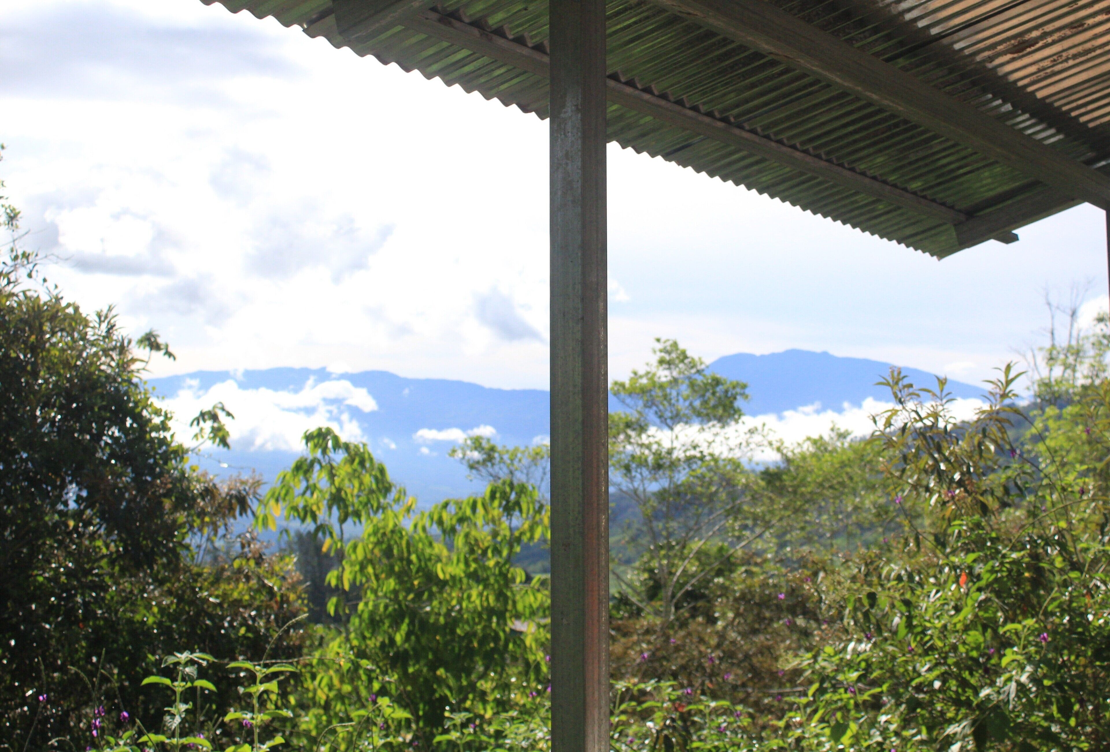 A covered outdoor area with a view of mountains in the background.