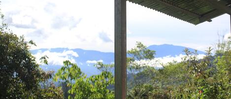 A covered outdoor area with a view of mountains in the background.