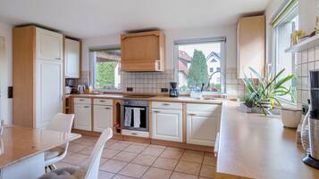 Fridge, stovetop, dishwasher, coffee/tea maker