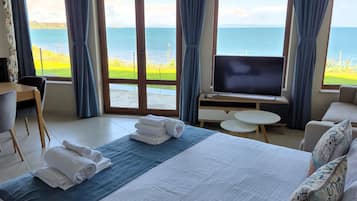 Deluxe Suite, Sea View | Premium bedding, down comforters, minibar, individually decorated