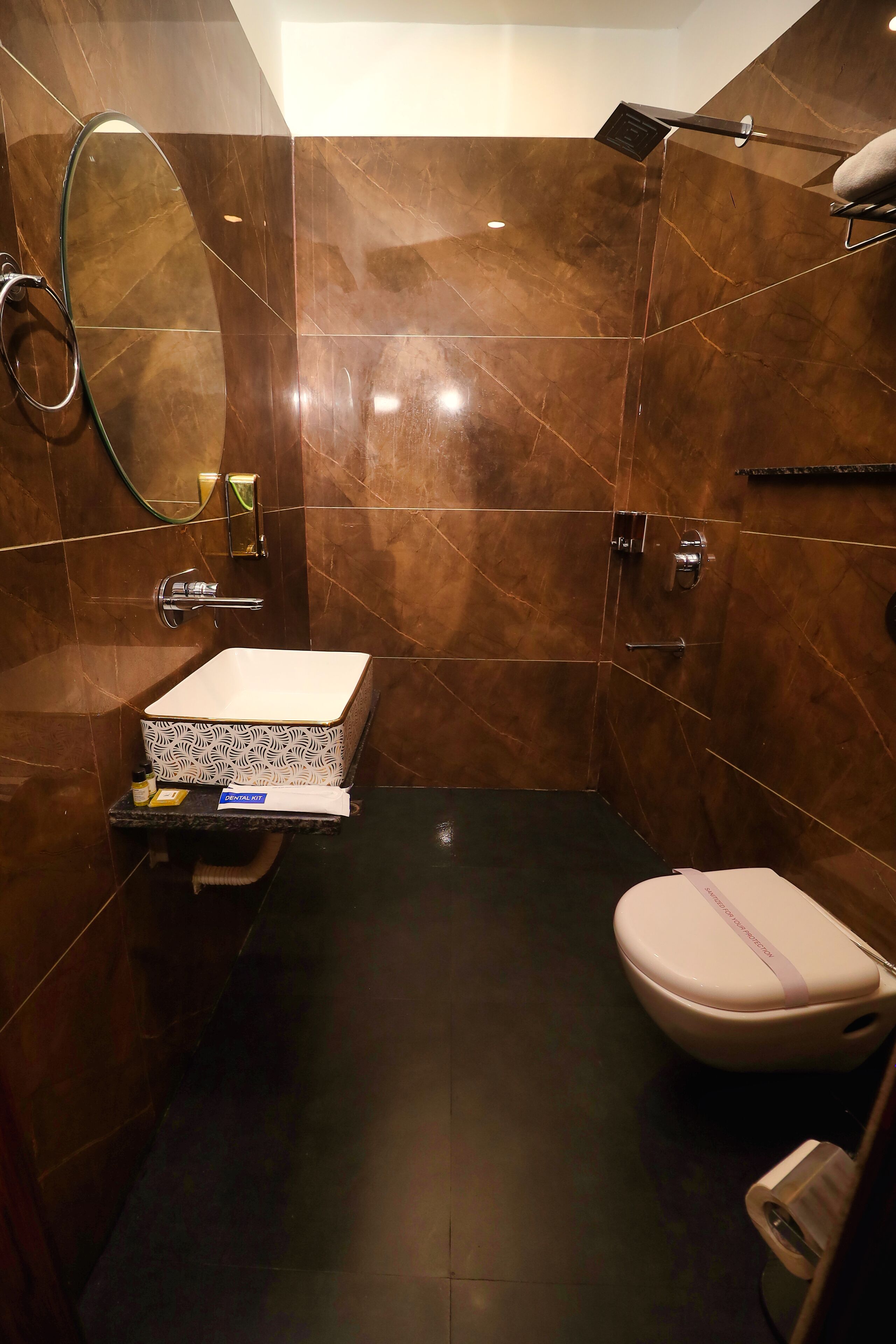 A bathroom with a white sink, a toilet, and a shower area.