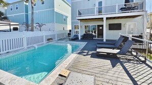 A two-story building with a pool and outdoor seating. - Beach Retreat Complex w/Pool - Sleeps 25! (Jacksonville Beach)
