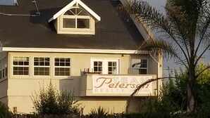 A two-story house with a sign for 'Team Peters Realty'.