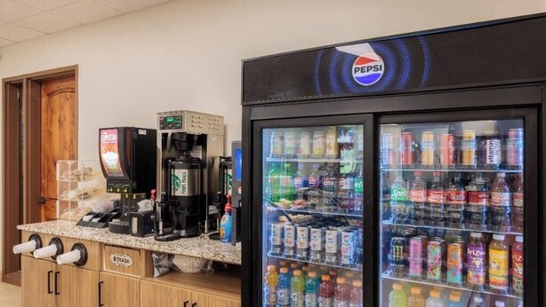 A self-service beverage station with a Pepsi refrigerator and a coffee machine. - 9th Hole Clubhouse Stroll (St. George)