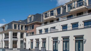 A modern multi-story residential building with balconies, large windows, and a clean facade. - Apartment in Domburg near the Beach (Domburg)