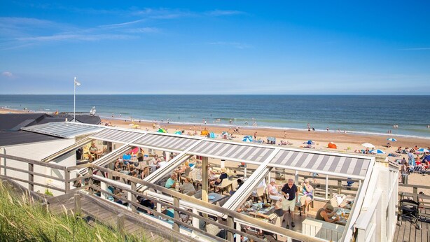 A beachside restaurant with outdoor seating overlooking the ocean. - Villa in Domburg near North Sea Beach (Domburg)