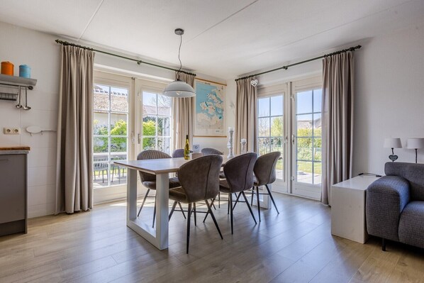 Enjoy meals in the dining area with a wooden table and four chairs.
