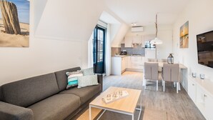 A modern apartment with a living area, dining space, and kitchen. - Apartment near Noordzee Dishoek Beach (Koudekerke)