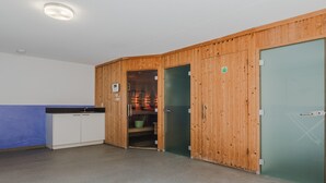 A room with a kitchenette, a shower area, and a green door. - Villa in Arcen with Private Pool & Wellness (Arcen)