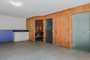 A room with a kitchenette, a shower area, and a green door. - Villa in Arcen with Private Pool & Wellness (Arcen)