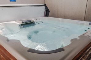 A hot tub with a built-in seat and jets, set against a plain wall. - Villa in Arcen with Private Pool & Wellness (Arcen)