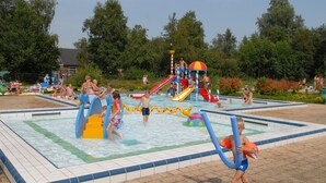 A water park with multiple slides and play areas. - Cozy Bungalow with Terrace (Eernewoud)