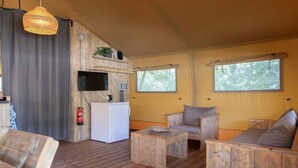 A cozy room with a wooden floor, a small white kitchenette, a flat-screen TV, and a large window. - Apartment in the Netherlands near Nature (Arcen)