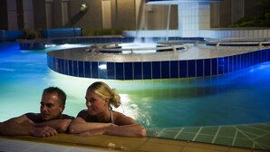 A swimming pool with a circular hot tub and a waterfall feature. - Apartment in the Netherlands near Nature (Arcen)