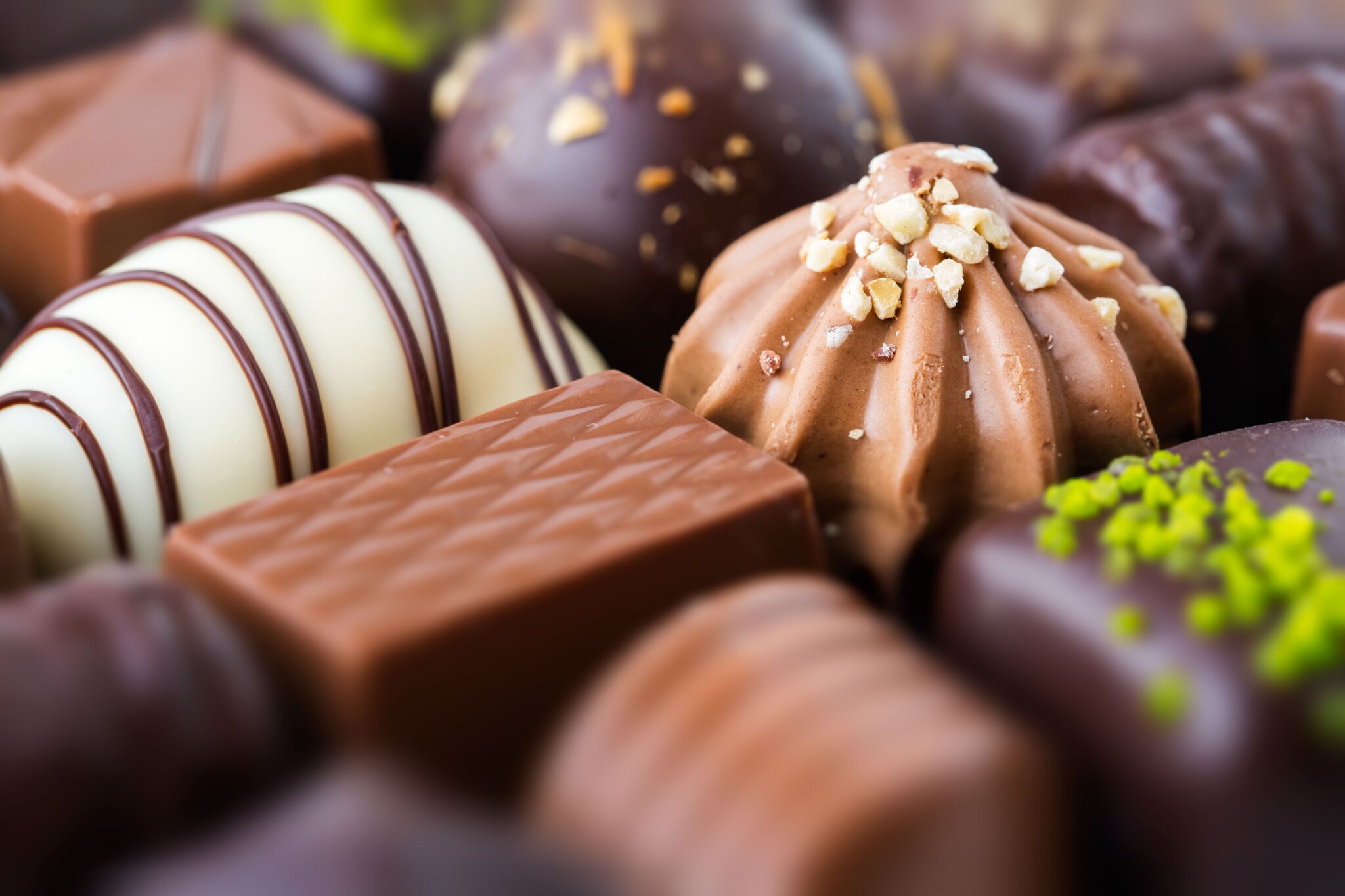 A variety of chocolate truffles in different shapes and sizes.