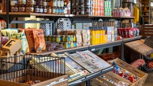 A grocery store with shelves stocked with various products, including jars, bags, and boxes.