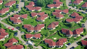 An aerial view of a residential area with houses, roads, and parked cars. - Bungalow near Dutch Beaches & Nature Trails (Domburg)