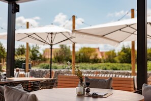 Relax in our shaded outdoor seating area, surrounded by lush gardens and elegant greenery.
