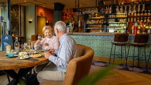 A couple dining at a restaurant with a bar in the background. - Cozy Volendam Getaway (Volendam)
