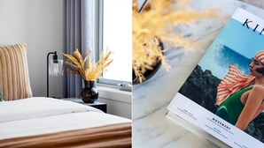 Une chambre d’hôtel avec un lit, une table de chevet avec une lampe et un vase contenant des fleurs séchées.