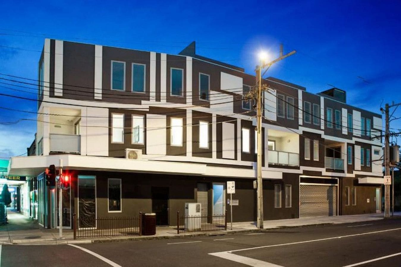 A multi-story building with a flat facade, large windows, and a visible ground-floor entrance.