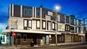 A multi-story building with a flat facade, large windows, and a visible ground-floor entrance.