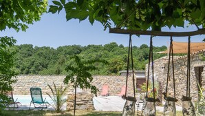 A stone wall, a swimming pool, and hanging glass jars with plants. - Holiday Gîte 'T1 Ardeche Vesseaux' with Mountain View, Shared Garden & Wi-Fi (Vesseaux)