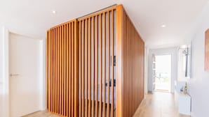 A room with a wooden partition, a white door, and a view of a balcony. - Apartment 'Top First Line  Altea' with Sea View, Wi-Fi and Air Conditioning (Altea)