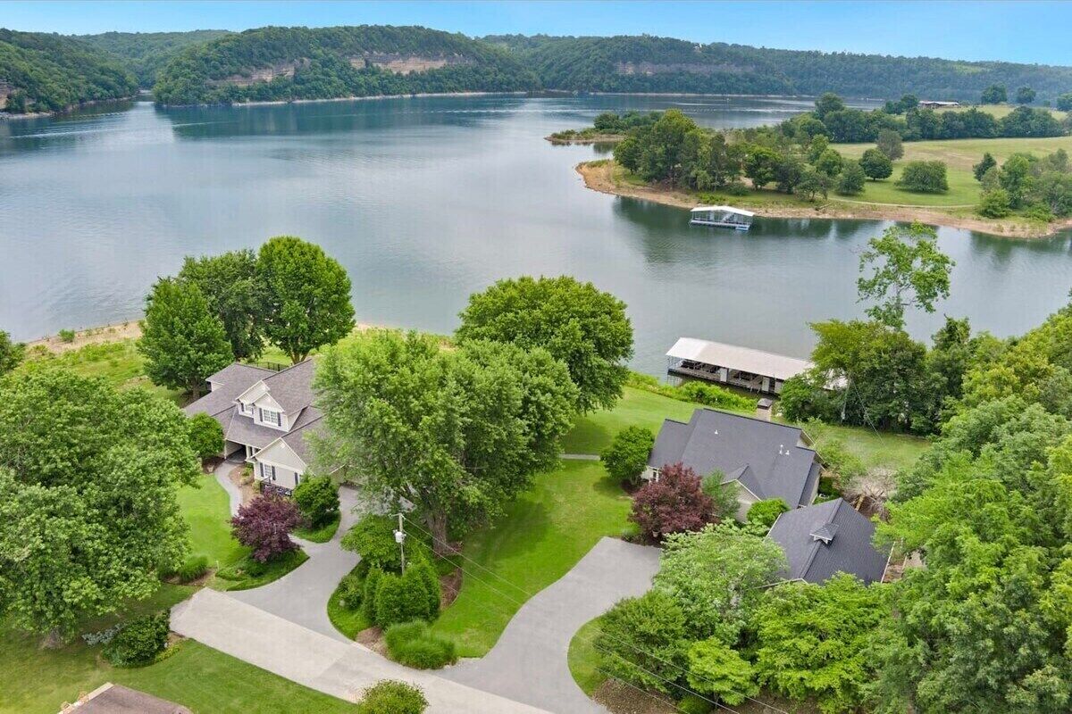 A residential area with houses, a lake, and a boat.