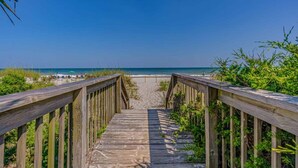 A wooden boardwalk leading to a beach with clear skies. - Ocean Forest Villas C310 - Oceanfront (Myrtle Beach)