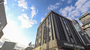 A modern hotel building with a sign reading "Welcome to Hotel Yam." - HOTEL YAM-GUMI (Gumi)