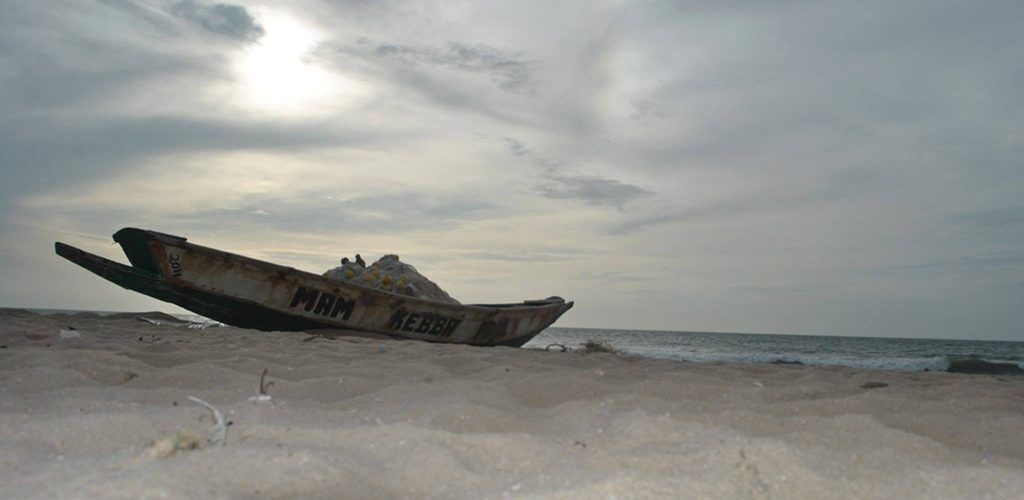 Een militair vliegtuig op een zandstrand, met de tekst "MAR" en "REB" zichtbaar op de zijkant.