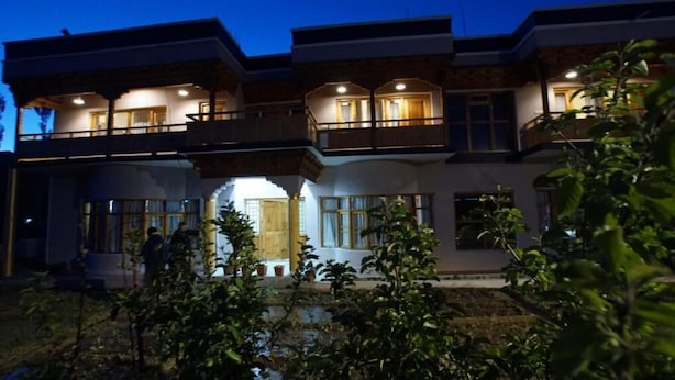 A multi-story building with balconies and a central entrance. - Gopa Residency Temisgam Village  (Leh)
