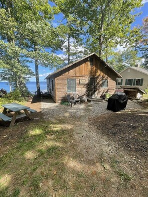 Enjoy meals or relax in the shaded outdoor seating area, surrounded by mature trees and scenic views.