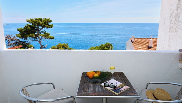 A balcony with a table, a chair, and a view of the sea. - Hedera Estate, Hedera A16 (Dubrovnik)