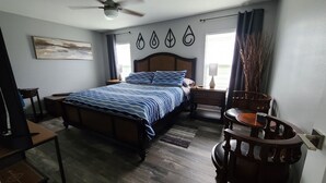 A bedroom with a bed, a desk, a chair, a ceiling fan, and a window with curtains. -  Lakefront Retreat w/ Dock, Kayaks & Sunset Views – Peaceful Escape! (Lake Placid)