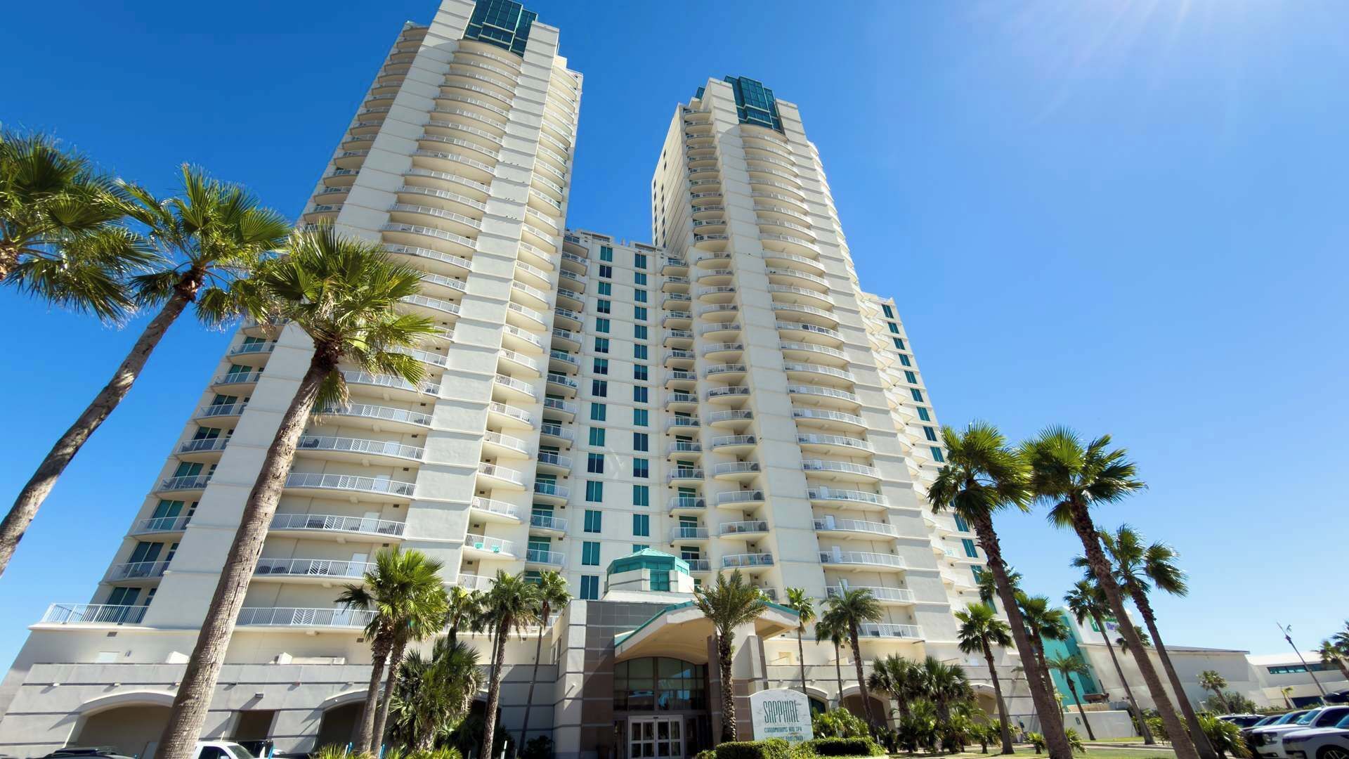 A high-rise hotel with a modern design, featuring multiple balconies and a prominent entrance.