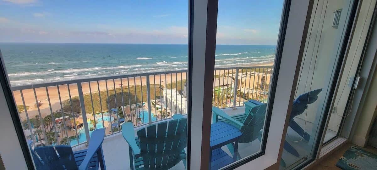 A balcony with a view of the ocean and beach.