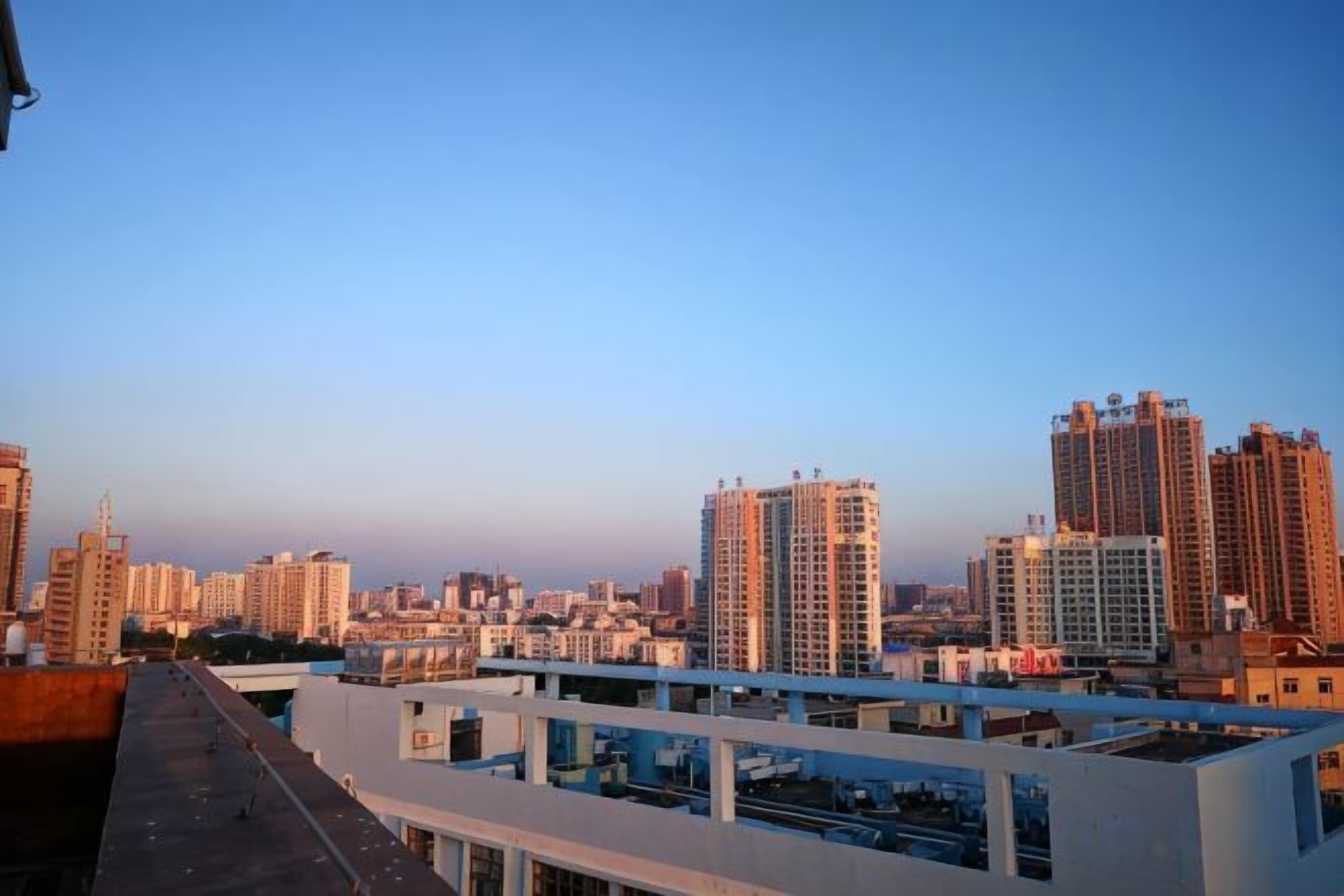 A cityscape with high-rise buildings and a clear sky.