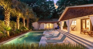 A pool area with lounge chairs and a covered seating area.
