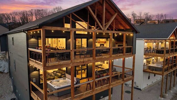 A multi-level wooden cabin with a balcony, a hot tub, and a fireplace. - Lake View|Pools·Sauna·Hot Tub|Game&Theater Room·24 (Branson)