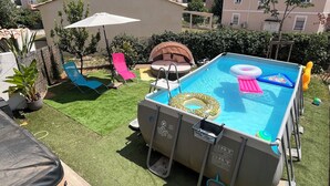 A backyard with a swimming pool, inflatable loungers, and a small deck area. - A 5 du Centre et des Plages, Maison Avec Jacuzzi (Sanary-sur-Mer)