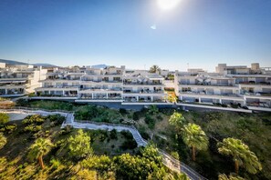 A modern hotel complex with multiple buildings, a central courtyard, and surrounding greenery. - Han | Mountain view - pool - terrace (Estepona)